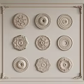 Various Decorative Ceiling Medallions with Ornate Patterns and Circular Designs on White Framed Wall