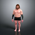 Muscular Shirtless Man in Black Shorts with Arm Wraps Barefoot Standing Against Gray Background