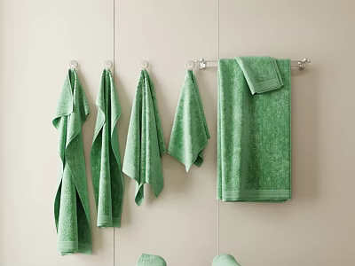 Set of Green Towels Hanging On Metal Hooks Against Beige Wall In Bathroom 3d model