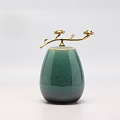 Elegant Green Ceramic Vessel With Golden Floral Ornament And Ovoid Shape