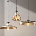 Modern Glass Pendant Lights With Three Different Shapes Illuminated In Minimalist Interior
