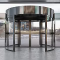Modern Building Entrance With Glass Revolving Door And Potted Green Plants