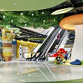 Vibrant Shopping Mall Lobby Featuring Escalators Children's Play Zone Green Decor And Modern Lighting