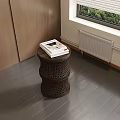 Woven Side Table With Magazine In Room Corner Near Wooden Cabinet And Window