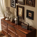 Ornamental Decor Set on Wooden Dresser with White Statue Vase Radio and Wall Paintings