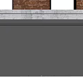 Gray Roller Shutter Installed On Brick Building Exterior With Concrete Lintel