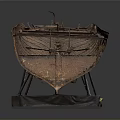 Old Rusted Boat Displayed On Black Metal Stand Against Gray Background