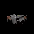 Modern Dining Table and Chairs Set Black Oval Top Brown Gray Chairs Fruit Bowl Glasses