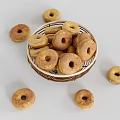Golden Brown Donuts in Wicker Basket with Scattered Pieces Around