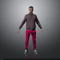 A man standing against gray background in dark purple jacket pink pants and silver shoes