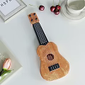 Wooden Ukulele and Art Supplies Displayed on White Table with Decorative Items