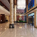 Elegant Front Desk Reception in Hotel Lobby with Marble Floor Tall Columns and Chandelier
