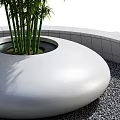 Park Landscape Featuring Circular Planter With Bamboo Plant And Gray Gravel Square Platform
