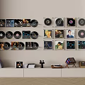 Headphones and Speakers Setup Featuring Wall Mounted Vinyl Records White Low Cabinet and Books