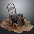 Rusted Garden Cart With Coiled Old Hose On Dirt Surface