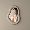 Irregular Shaped Mirror With Neutral Frame On Light Beige Wall Reflection Of Woman In White