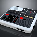 Portable Electronic Living Device With White Case Black Panel Red Buttons Knobs And