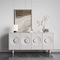 White Console Cabinet With Circular Door Design Table Lamp Vase Books And Artwork