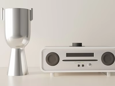 Decorative Ornaments Set With Silver Goblet Shaped Ornament And White Speaker Device On Light Table 3d model