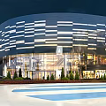 Modern Large Building With Blue White Striped Glass Curtain Walls Night Lighting Trees And Roads