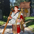 Game Movie Character Roman Soldier Wearing Armor Red Tunic with Spear Near Ancient Ruins