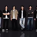 Group of Six Young Men Standing in a Row With Casual Outfits Against Dark Backdrop