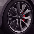 Silver Tesla Sedan With Sleek Modern Exterior And Black Alloy Wheels