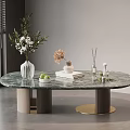 Modern Oval Marble Coffee Table With Gold Cylindrical Bases And Decorative Vase Plants Books