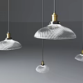Multiple Modern Pendant Lights With Glass Shades And Brass Bases For Interior Design
