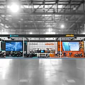 Segway Exhibition Booth In Indoor Hall With Large Screens And Displayed Vehicles