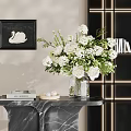 White Floral Arrangement In Glass Vase On Marble Table With Swan Painting And Books