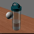 Transparent Cup With Green Lid And White Ball On Wooden Table Surface
