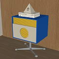 Blue and White Bedside Table with Yellow Drawer Wheeled Base Books and Triangular Decor 3d model