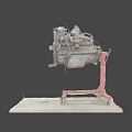 Old Engine on Red Rolling Stand with Mechanical Components Display on Workshop Workbench