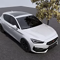 White Sporty Hatchback Car Parked On Gray Asphalt With Black Rims Near Yellow Leaf Tree