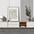 Modern White TV Stand With Drawers Open Compartment Green Plant Vase Lamp And Wall Art
