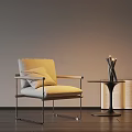 Beige Upholstered Accent Chair With Metal Frame And Side Table With Candles And Open Books