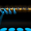 Stage Decorative Lights Arranged on Truss with Blue Yellow Light Beams Illuminating Stage