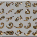 Golden Decorative Sculpture Carvings With Intricate Curved Patterns And Scroll Designs