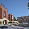 Red Brick School Building With Dome Arched Entrance Courtyard Pool Green Plants And Trees