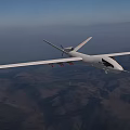 High Altitude Fighter Jet Flying Over Mountainous Terrain With Clear Sky