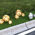 Geometric Shaped Gold and Silver Outdoor Lights Illuminated on Green Lawn with Plants