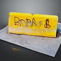 Yellow Road Barrier With Graffiti Featuring BOBA Text And Symbol On Concrete Ground