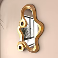 Gold Decorative Mirror With Wavy Frame And Circular Accents On Beige Wall