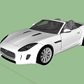 White Jaguar Convertible Driving On Open Road With Sporty Design Black Wheels And Red Interior