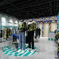 Modern Clothing Store Interior With Various Clothing Displays And Racks