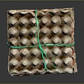 Stacked Paper Egg Cartons Tied With Green String Containing Brown Eggs