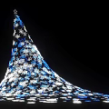 Illuminated Conical Art Installation Featuring Blue White Patterns Expanded Base And Star Top