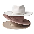 Three Stacked Hats With Different Light Tones And Satin Ribbons