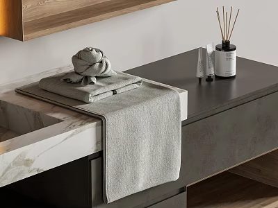 Folded Gray Towel on Bathroom Countertop with Aromatherapy Sticks and Decorative Bottles 3d model